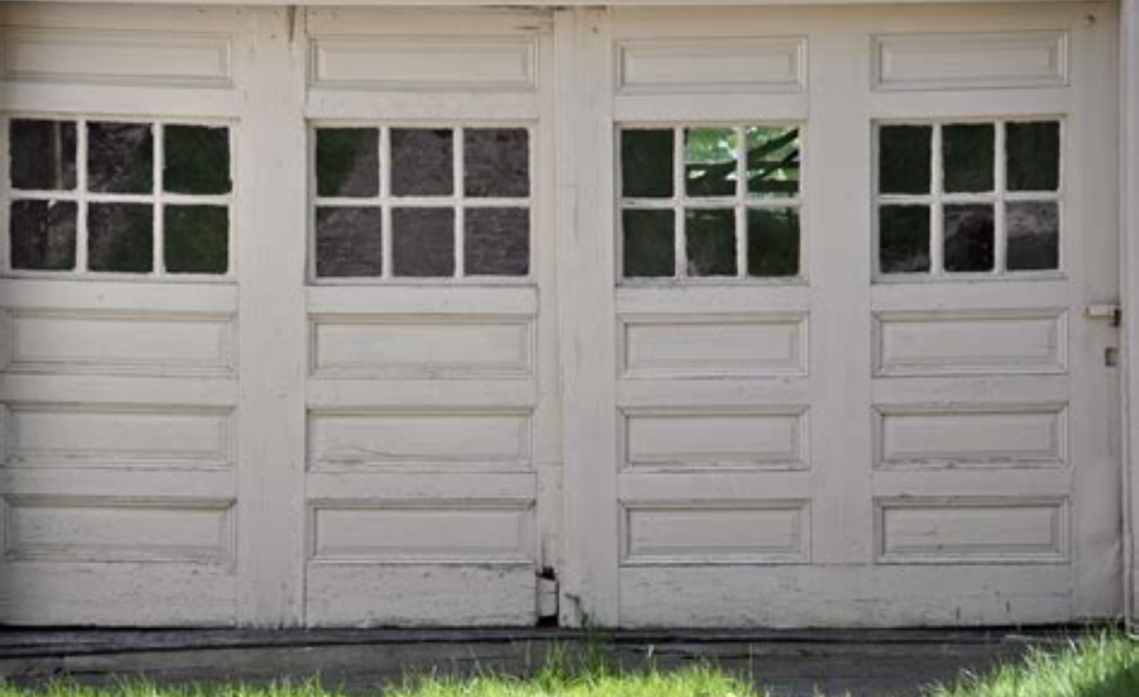 Close-up of a rusty, weathered metal door showing texture and decay.