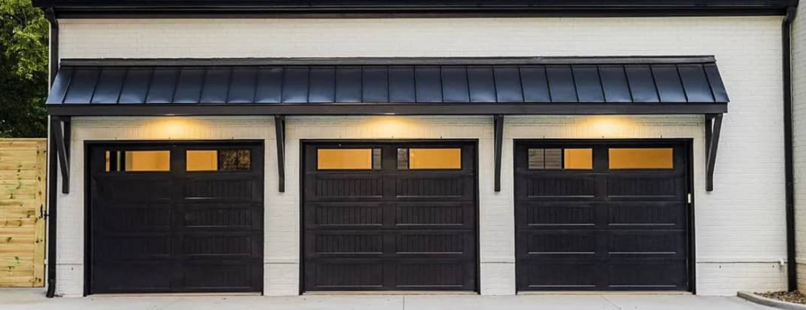 Luxury black Lamborghini in a contemporary garage setting with wheels and tools.