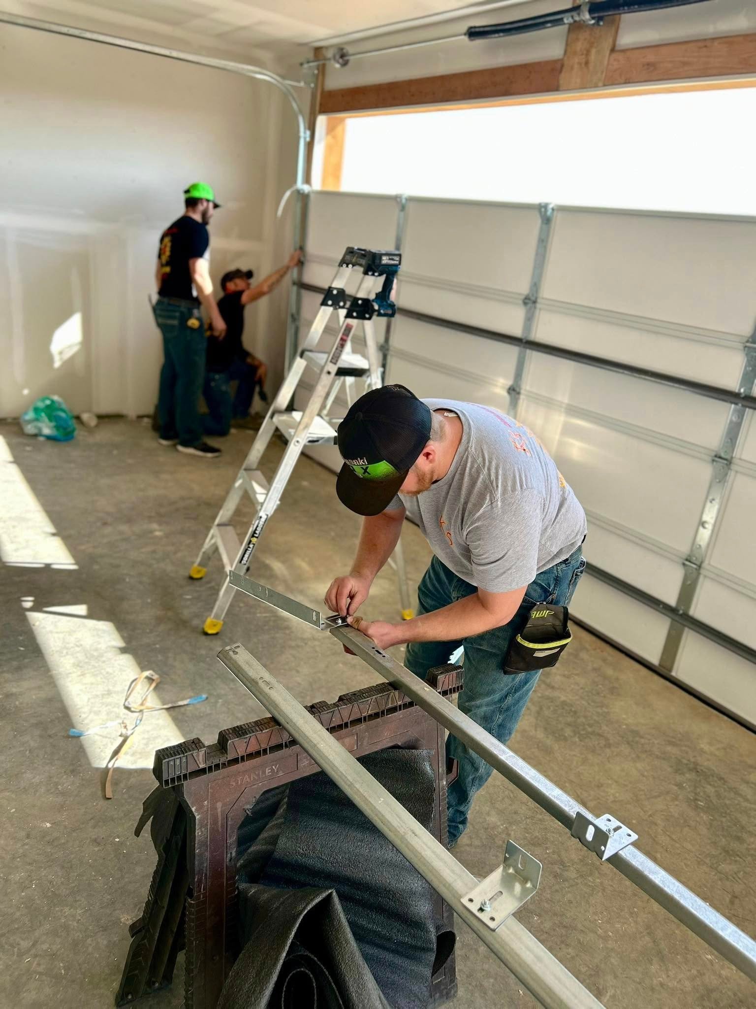 Two closed garage doors inside an empty warehouse space.